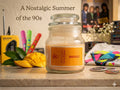 Velvet Mango soy wax candle by Melange Aroma, showcasing its premium fragrance blend in an elegant jar against a backdrop of fresh, sliced tropical mangoes.
