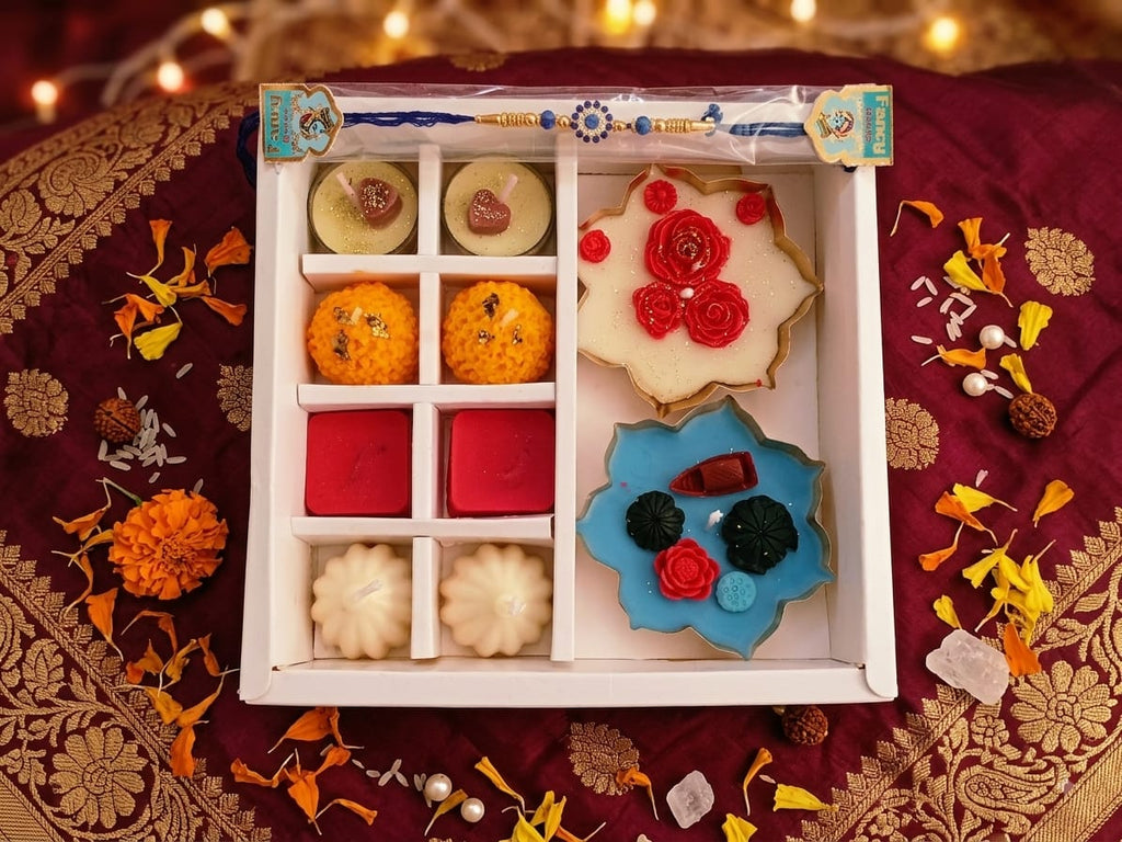 Rakhi Utsav gift hamper featuring soy candles, sweets, rakhi and urli candle