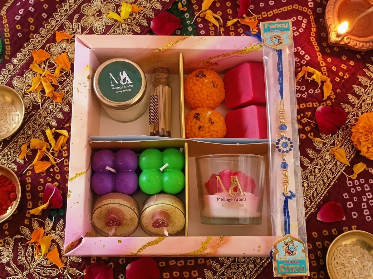 Mini Melange Rakhi gift box with soy candles and rakhi displayed on a neutral background"